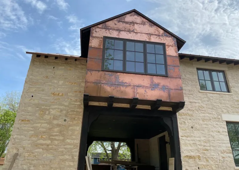 Copper metal panel facade on a stone building for Metal Roof Coating in Romeoville