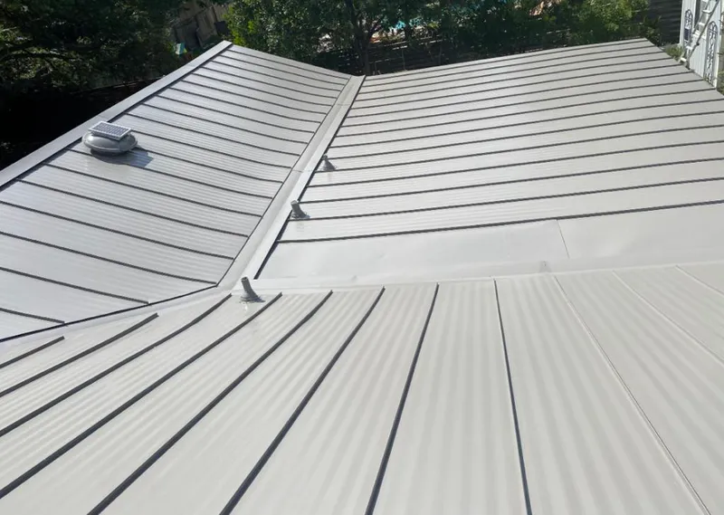 Solar attic fan installed on a metal roof for Roof Ventilation in Romeoville